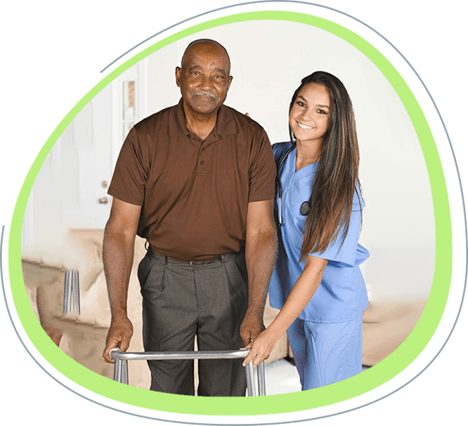 A man using a walker with a caregiver.